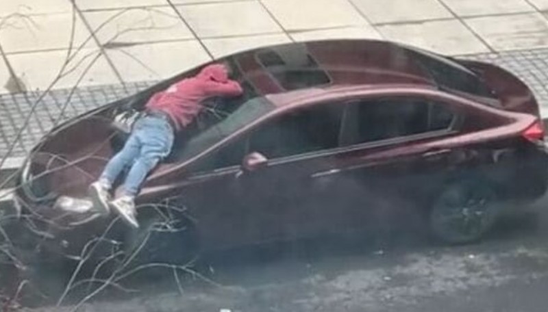 Watch: Man falls asleep on the Windshield of a moving Honda car