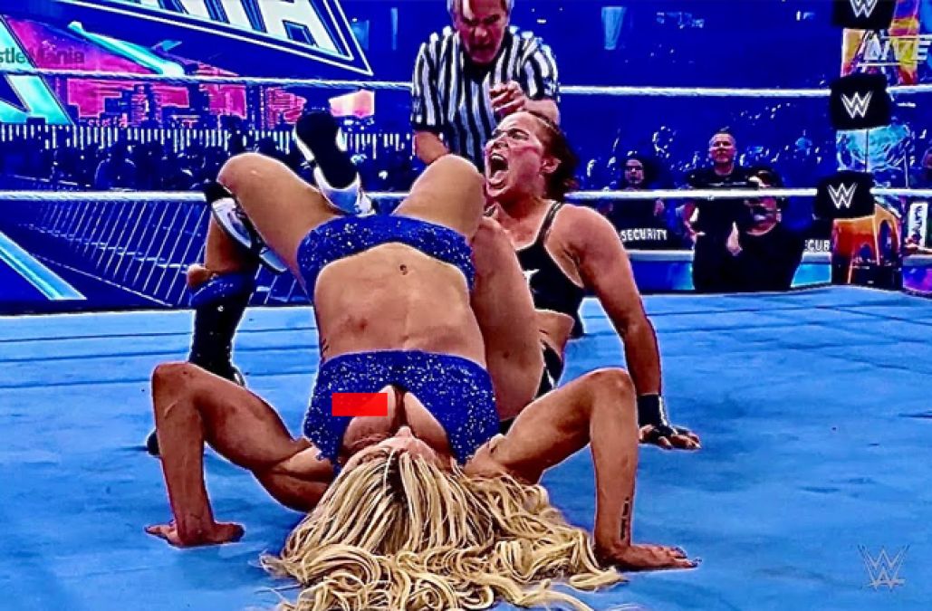 Charlotte Flair, who is playing a match against Ronda Rousey at WrestleMani...