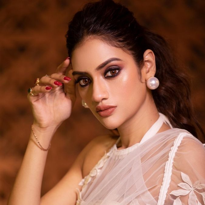 Nusrat sets the fire of beauty in a white transparent saree