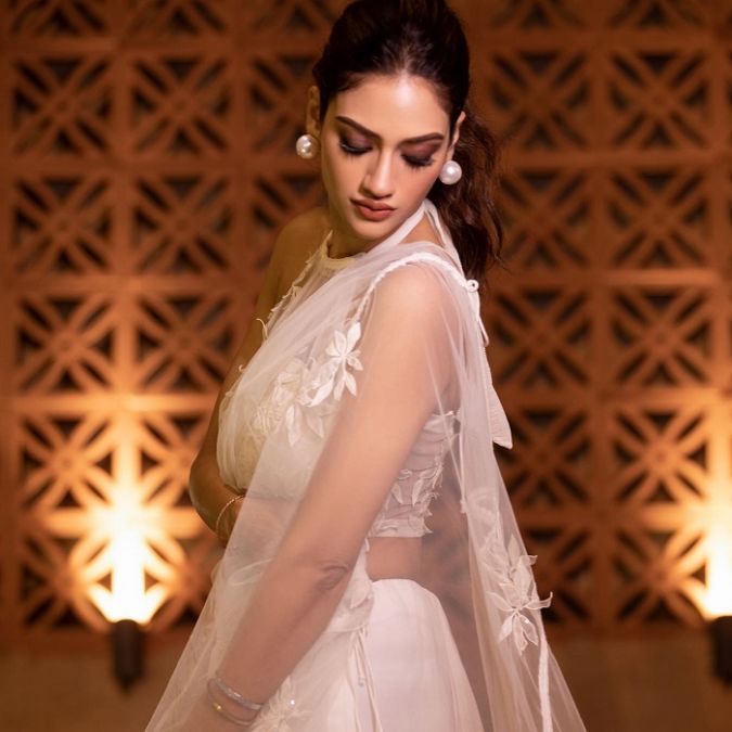 Nusrat sets the fire of beauty in a white transparent saree