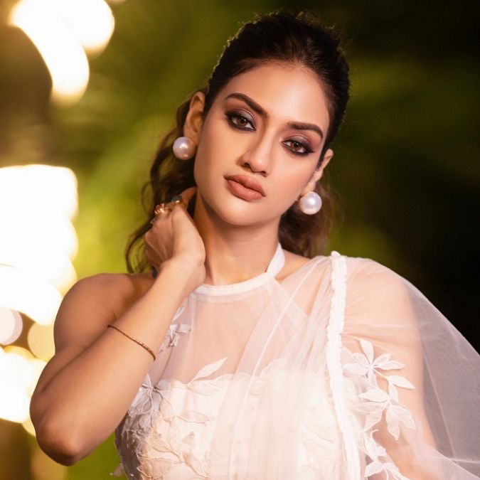 Nusrat sets the fire of beauty in a white transparent saree