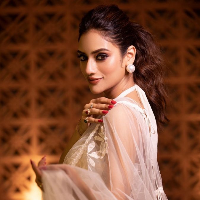 Nusrat sets the fire of beauty in a white transparent saree