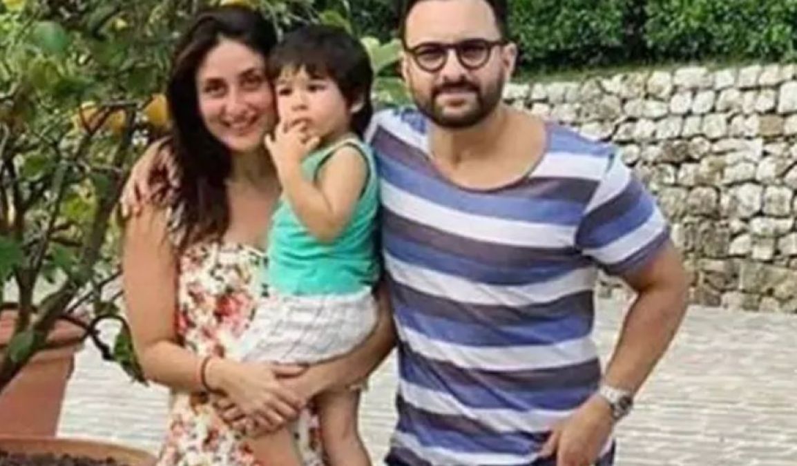 Taimur wrapped by Papa Saif's feet in the streets of London, watch video