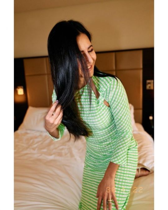 Katrina wreaks havoc in green and white check dress