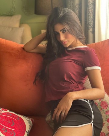 Mouni flaunts glamorous look by combining black shorts with a maroon top
