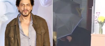 Shah Rukh Khan hides behind umbrella to avoid photographers