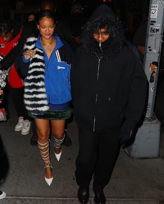 Rihanna spotted with her boyfriend in a blue and black windbreaker jacket