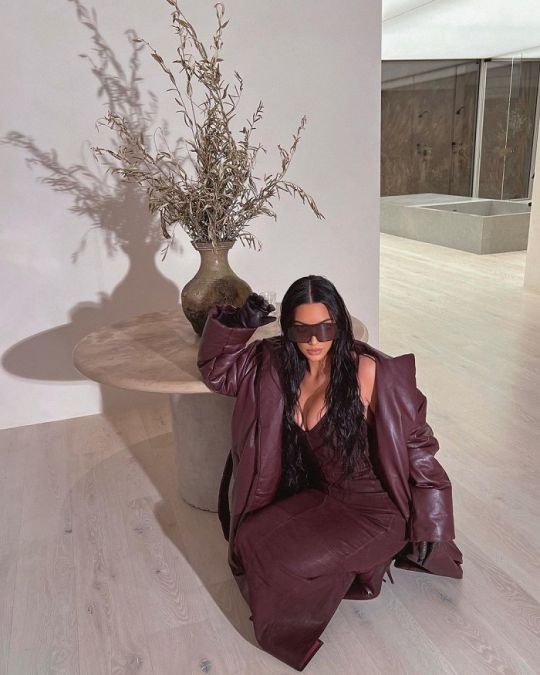 Wearing a coat with a brown dress, Kim added a touch of beauty