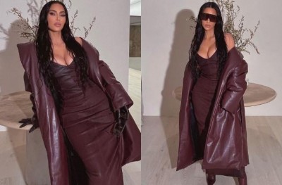 Wearing a coat with a brown dress, Kim added a touch of beauty