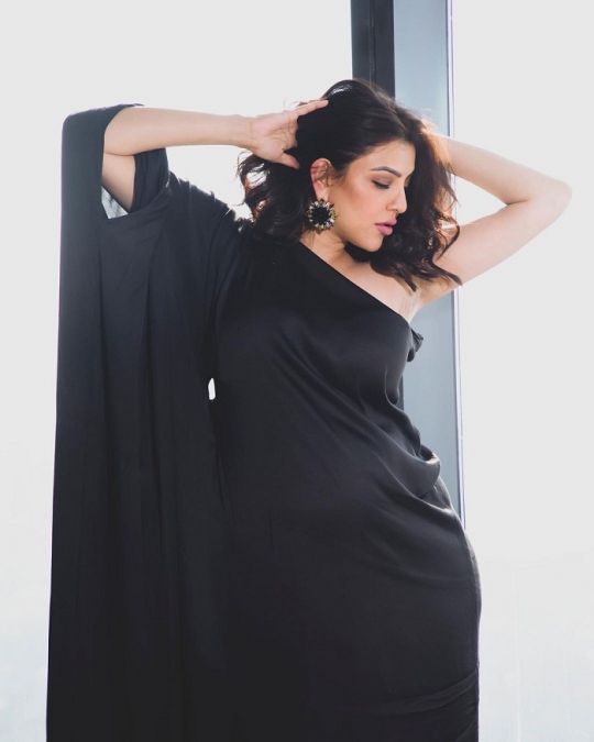 Kajal Aggarwal flaunts baby bump in a black dress