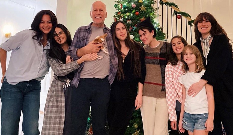 Pictures of Bruce Willis holidays show him cuddling with a pup