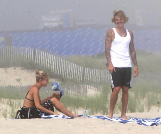 Justin and Hailey enjoy a romantic beach picnic