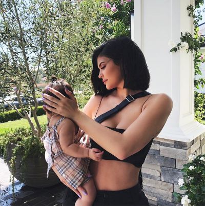 Kylie Jenner flaunts her diamond jewelry with daughter Stormi in arms