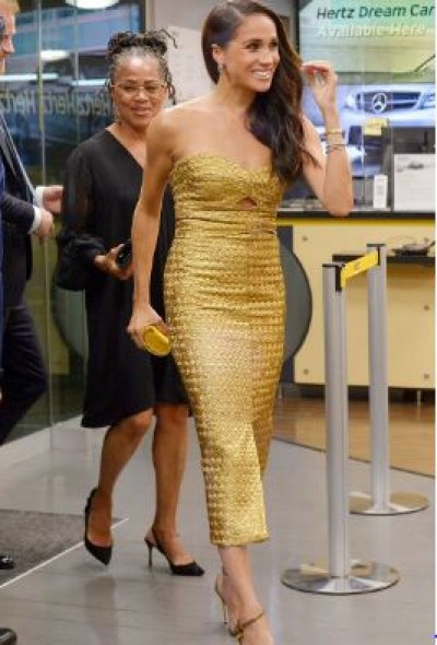 As she accepts the Women of Vision award, Meghan Markle gleams in gold.