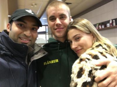 SEE PHOTO: Hailey Baldwin cuddles up to Justin Bieber as they pose for a selfie with a fan
