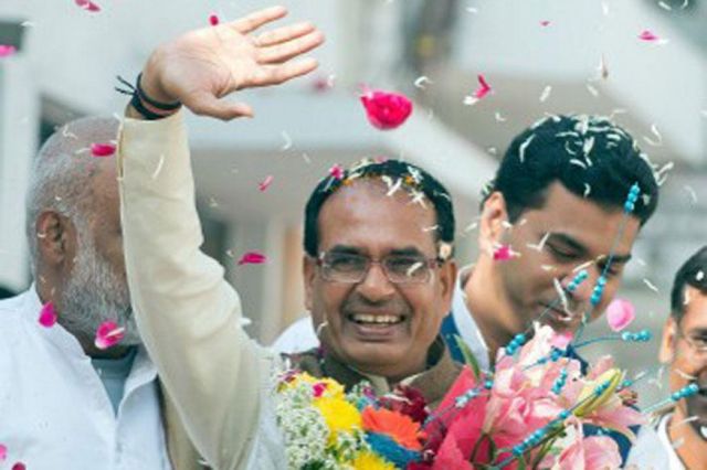 Shivraj’s security man carries his shoes in hand