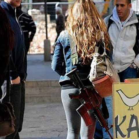 Israeli girls walking in streets along with Guns!!