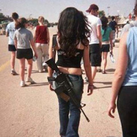 Israeli girls walking in streets along with Guns!!