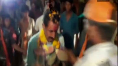 WATCH: Unknown Man garlands BJP MLA with shoes in public rally, gets beat by supporters