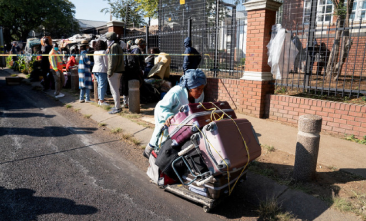 Evicts asylum seekers camped outside the UN refugee office in South Africa