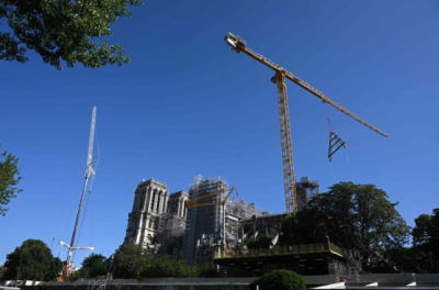 Notre Dame Reconstruction Takes Flight: Trusses Hoisted to Roof