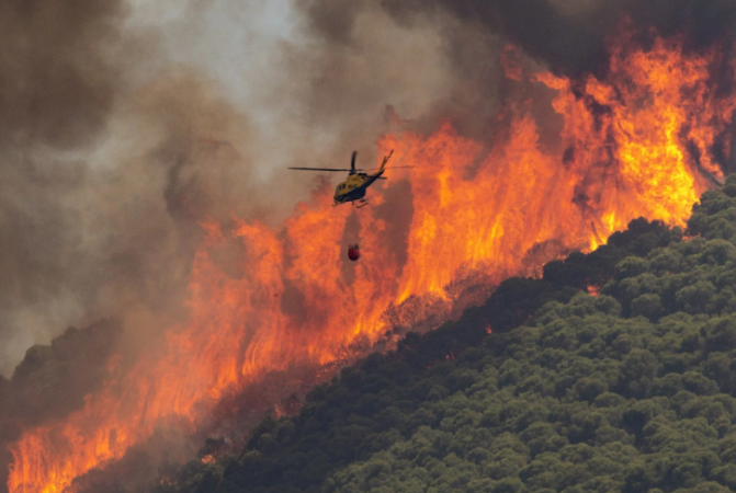 People are evacuated as a blazing heatwave in Europe started wildfires