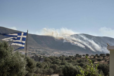 North of Athens, a wildfire burns forests; fires in the southeast and west grow weaker