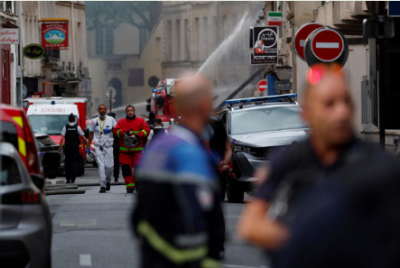 Rescuers search through building explosion debris in Paris