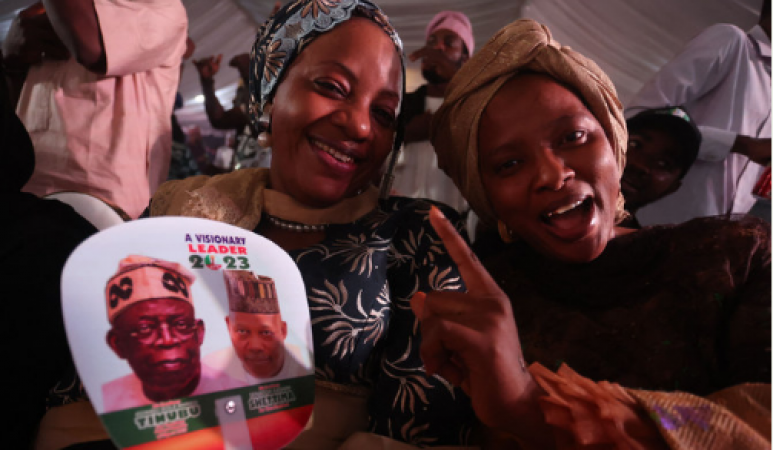The newly elected president of Nigeria extends a hand to contesting voters