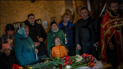 Family members bury kids who died in a Russian missile attack