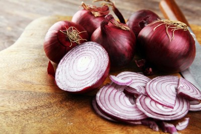 How should onion be eaten raw or cooked?