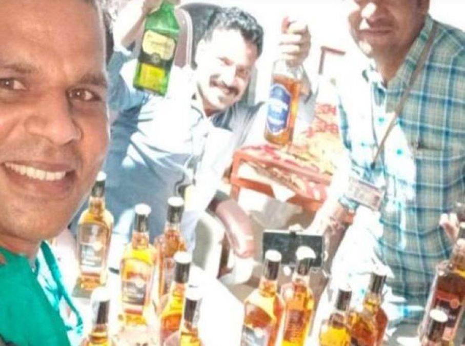 Revenue official suspected after selfie holding liquor bottle went viral