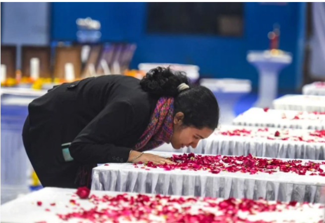 General Rawat's daughters stared at the coffin before the final farewell