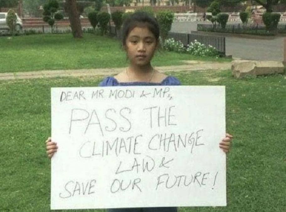 8 years old girl stands outside Parliament for climate change