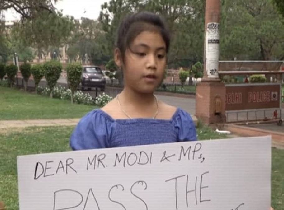 8 years old girl stands outside Parliament for climate change