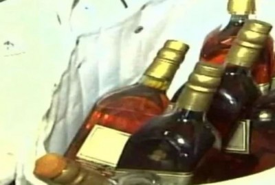 Police personnel takes alcohol from a shop, investigation underway