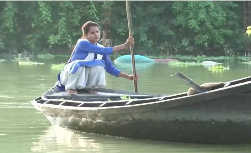 No smartphone for online class, sandhya goes to school by boat every day in floods