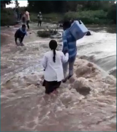 Karma is worship: Health workers overflowing river, Delivering life-saving vaccines
