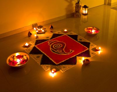 Why do Hindus create Rangoli and what are the beliefs related to it?