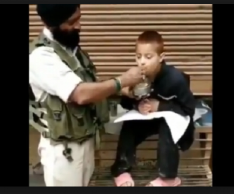 A Twitter Video Went Viral when CRPF personnel feed a physically disabled child with his hand