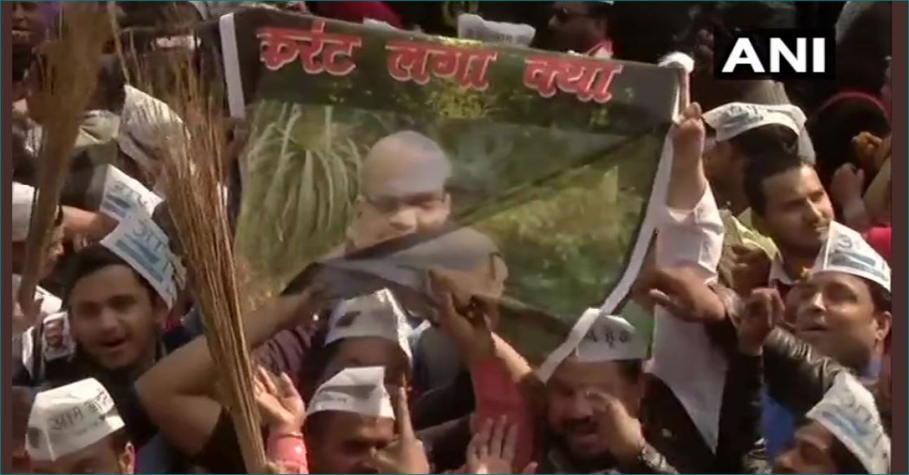 Delhi Results Live: AAP worker waving Amit Shah's poster - 'Current Laga Kya?'