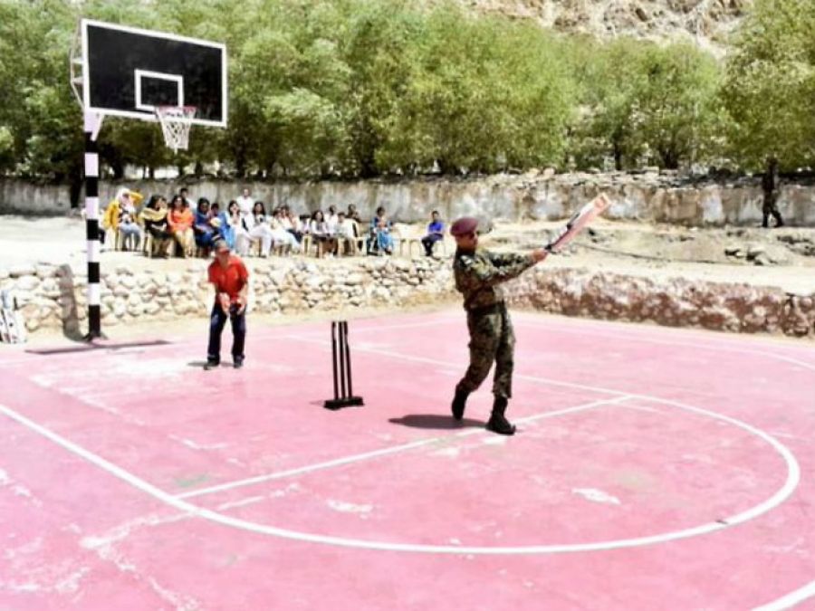 MS Dhoni plays cricket with children in military uniform