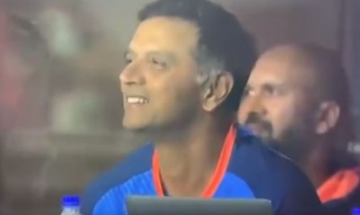Indian Coach Rahul Dravid laughs after seeing his own records on screen in a live match