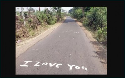 Lover paints loving words for a girl on a road