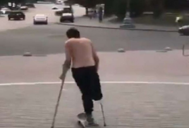 Disabled person performs stunts with skateboard
