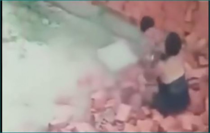 VIDEO: Mother saves child from being buried under the wall